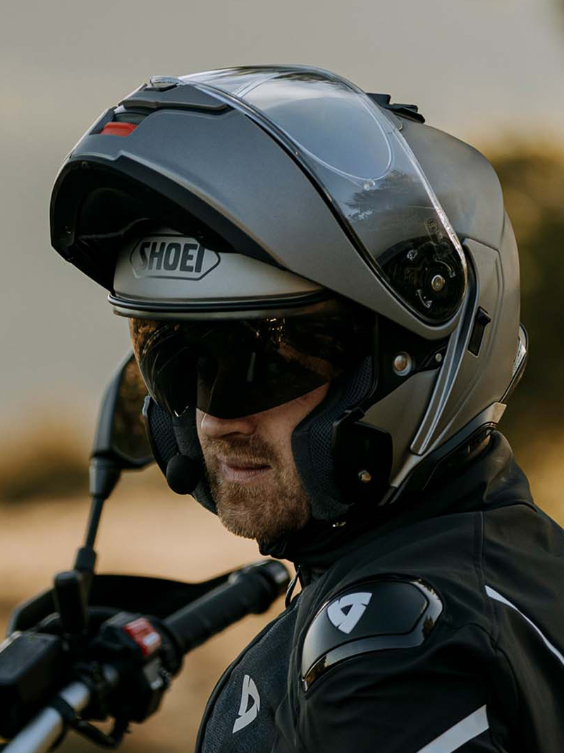 Guy wearing Shoei Neotec 3 with chil bar flipped up